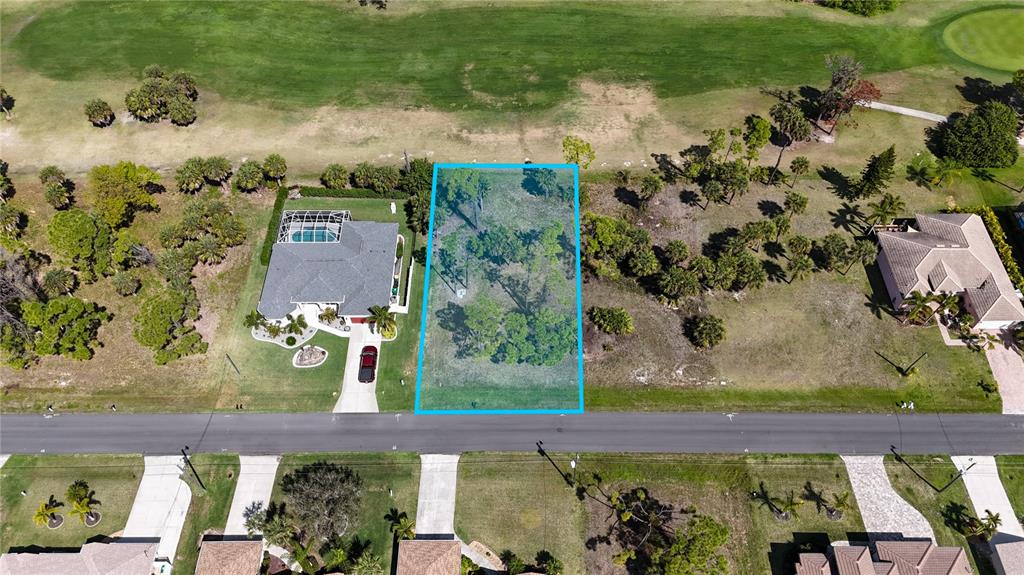 An aerial view shows a vacant residential lot outlined in blue next to a house — 242 MARKER ROAD, ROTONDA WEST, FL