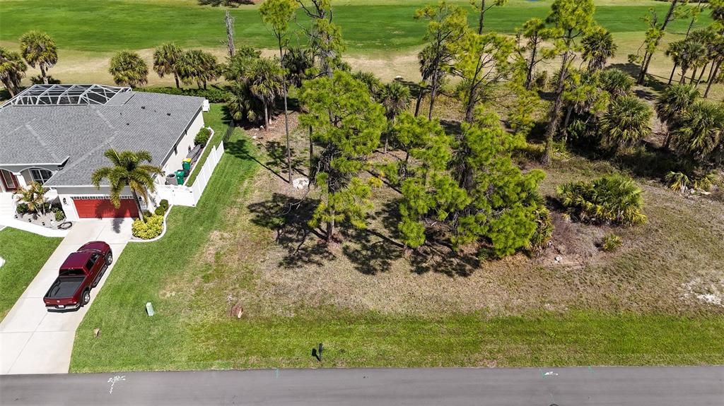 An aerial view shows a house with a red truck parked in the driveway — 242 MARKER ROAD, ROTONDA WEST, FL
