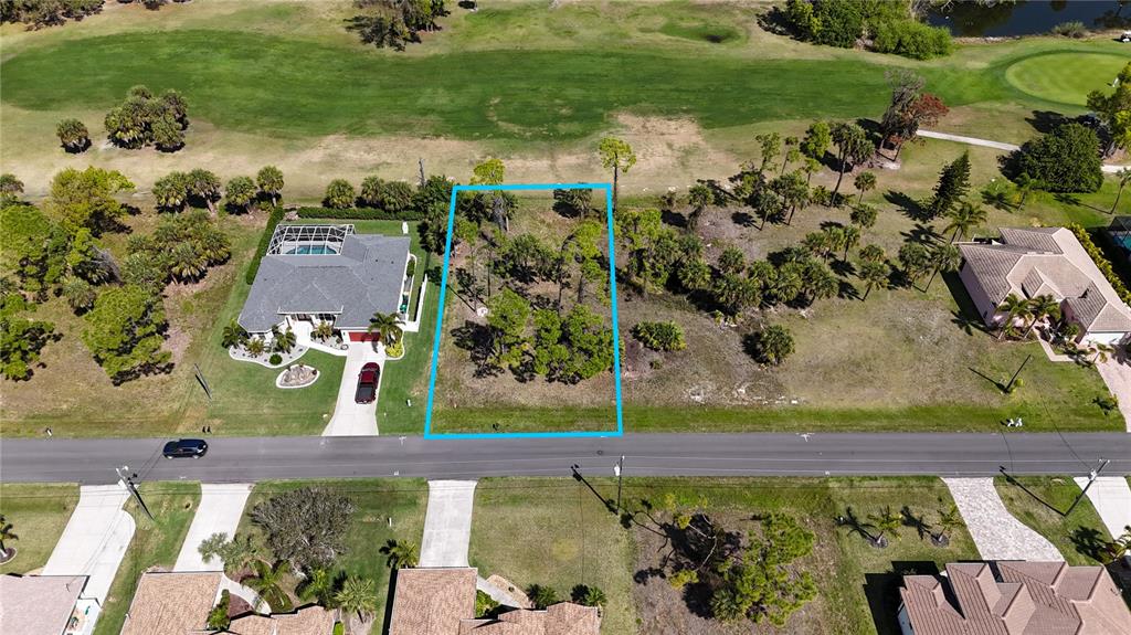 An aerial view shows a vacant, rectangular lot outlined in blue situated along a road — 242 MARKER ROAD, ROTONDA WEST, FL