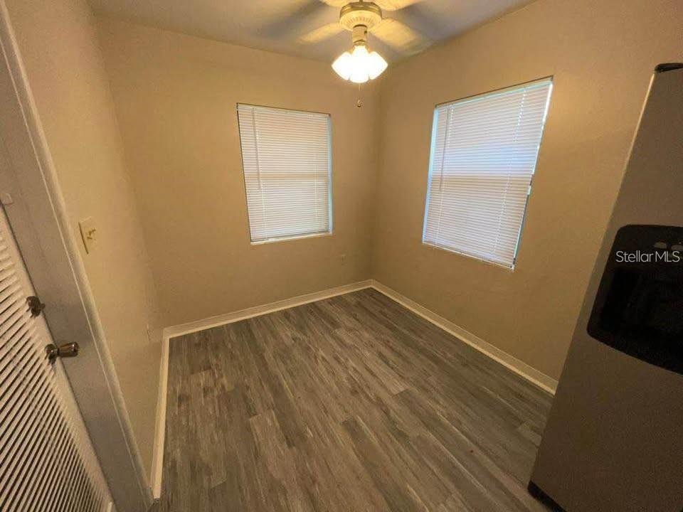 A small room with light-colored walls, gray wood-look flooring, two windows with blinds, and a ceiling fan — 331 STEEDLY AVENUE, LAKE WALES, FL