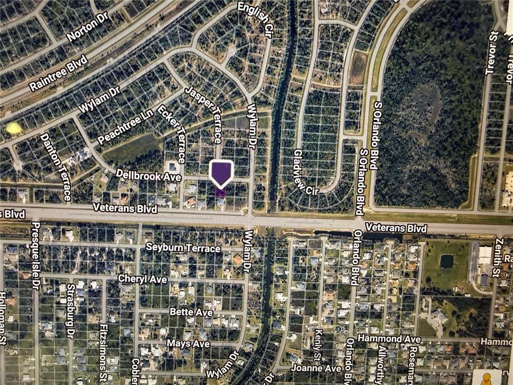 This is an aerial map view of a residential neighborhood with a highlighted property — DELLBROOK AVENUE, NORTH PORT, FL