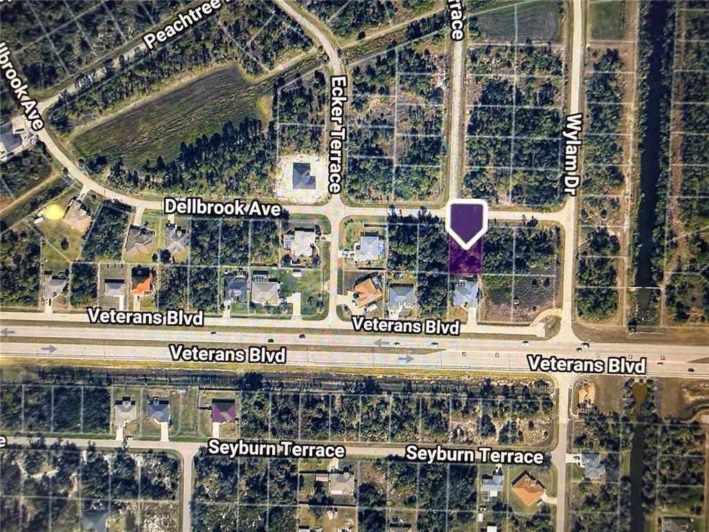 This is an aerial map view of a residential neighborhood with a highlighted property lot — DELLBROOK AVENUE, NORTH PORT, FL