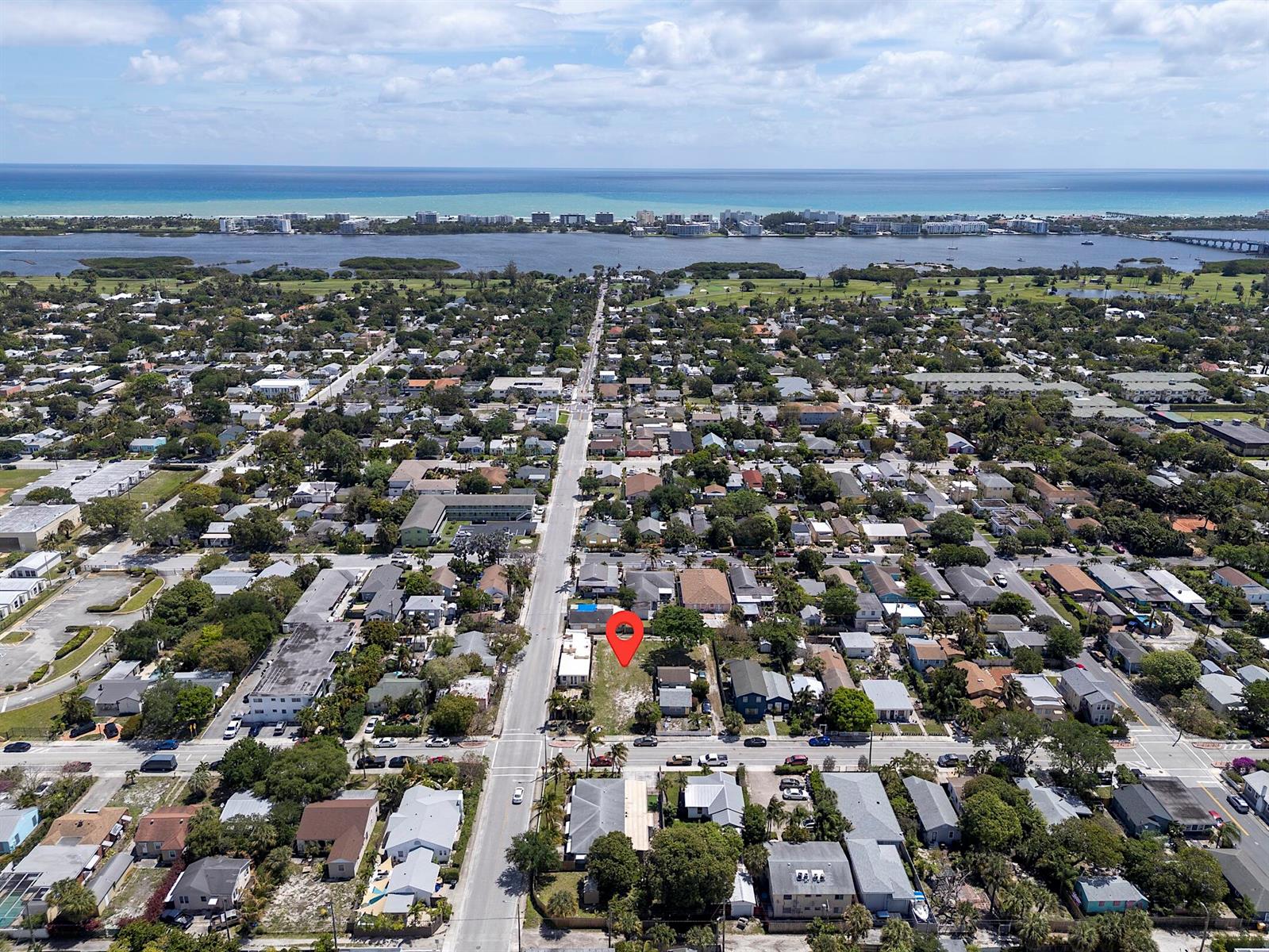 An aerial view shows a residential neighborhood with a red pin marking a vacant lot — 628 N K Street, FL 33460, FL