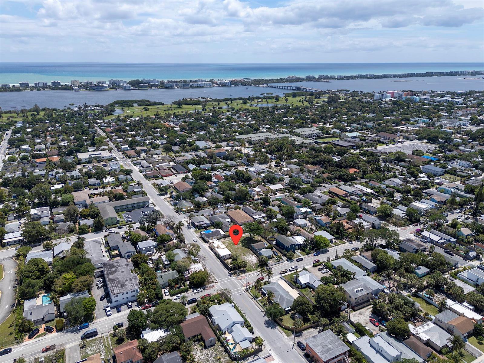 An aerial view shows a residential neighborhood with a red pin marking a vacant lot — 628 N K Street, FL 33460, FL