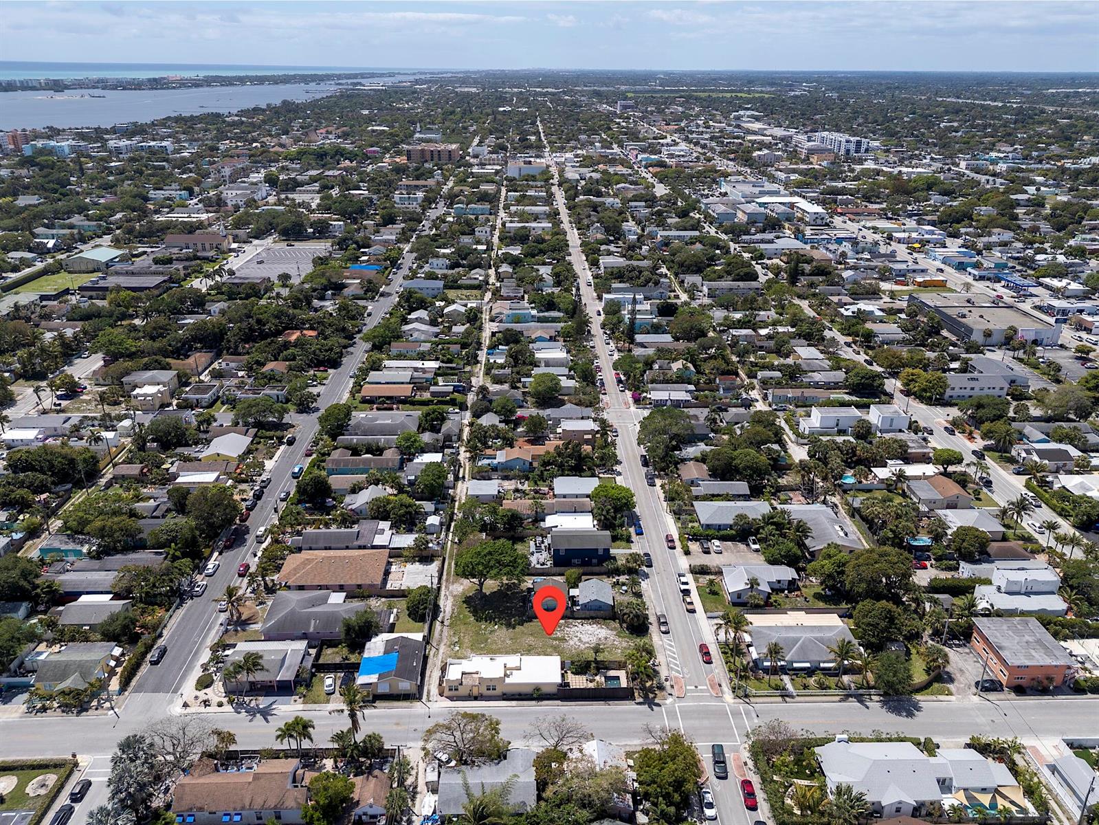 An aerial view shows a residential neighborhood with a red pin marking a vacant lot — 628 N K Street, FL 33460, FL