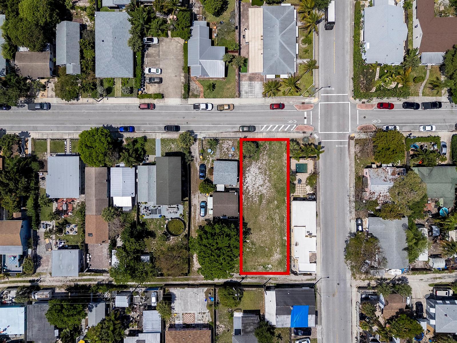 An aerial view shows a vacant rectangular lot outlined in red within a residential neighborhood — 628 N K Street, FL 33460, FL