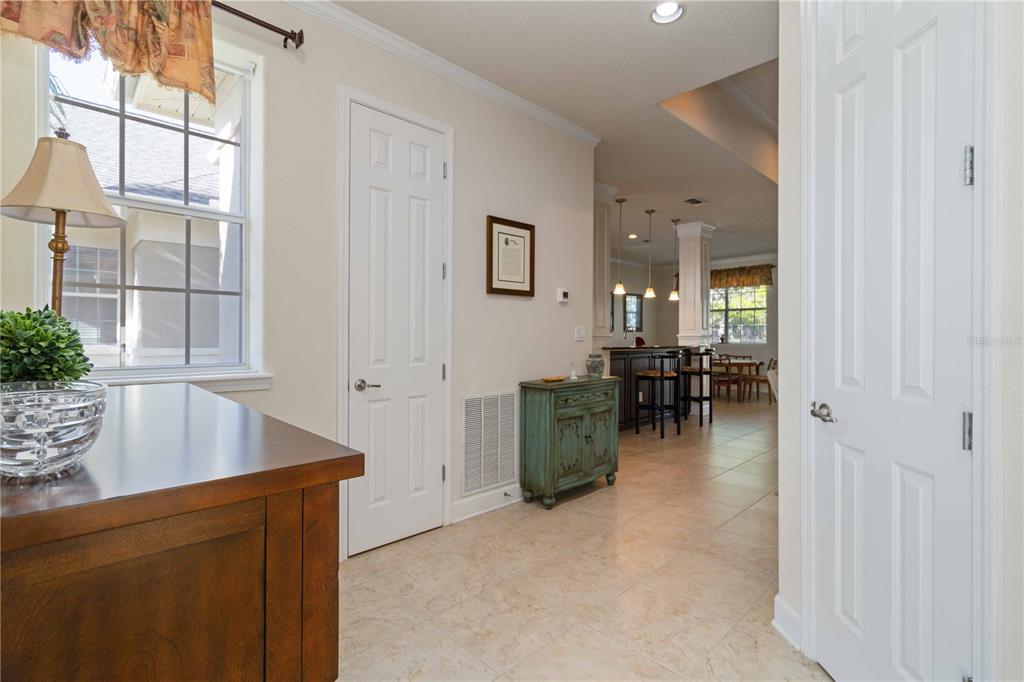 A view of a tiled hallway leading to a kitchen with a breakfast bar — 7954 TYBEE COURT UNIT 7954, UNIVERSITY PARK, FL