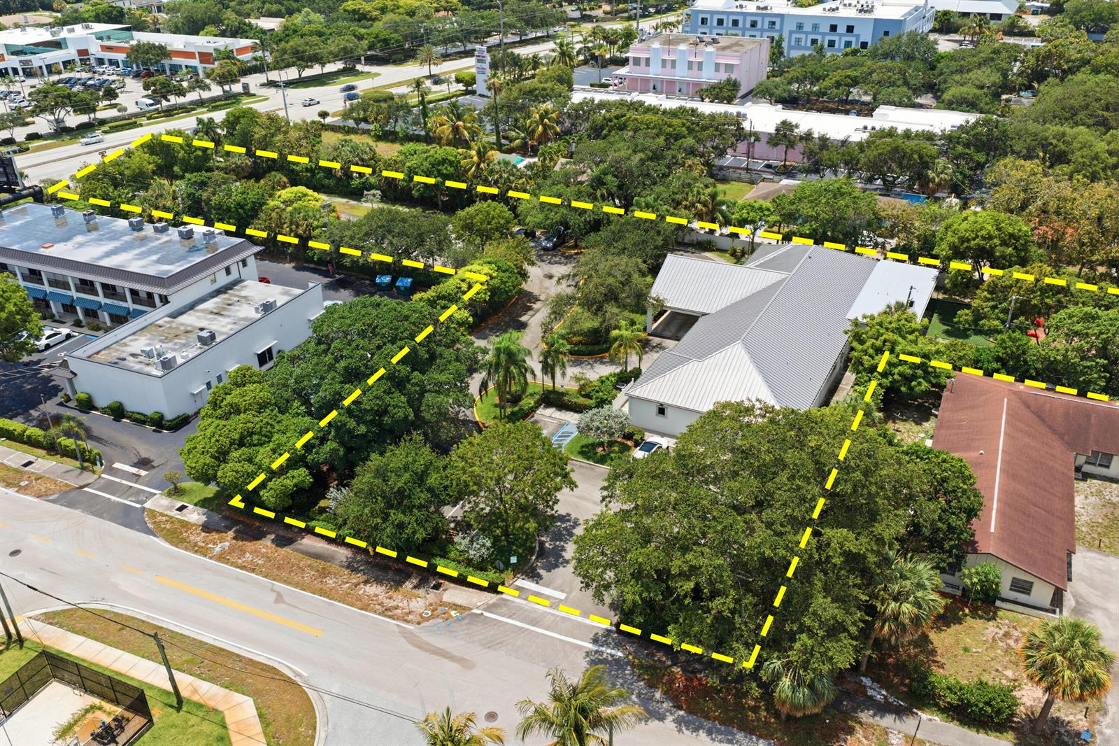 An aerial view shows a commercial property with two buildings, parking, and mature trees — 11981 Us Highway 1, Juno Beach FL 33408, JUNO BEACH, FL