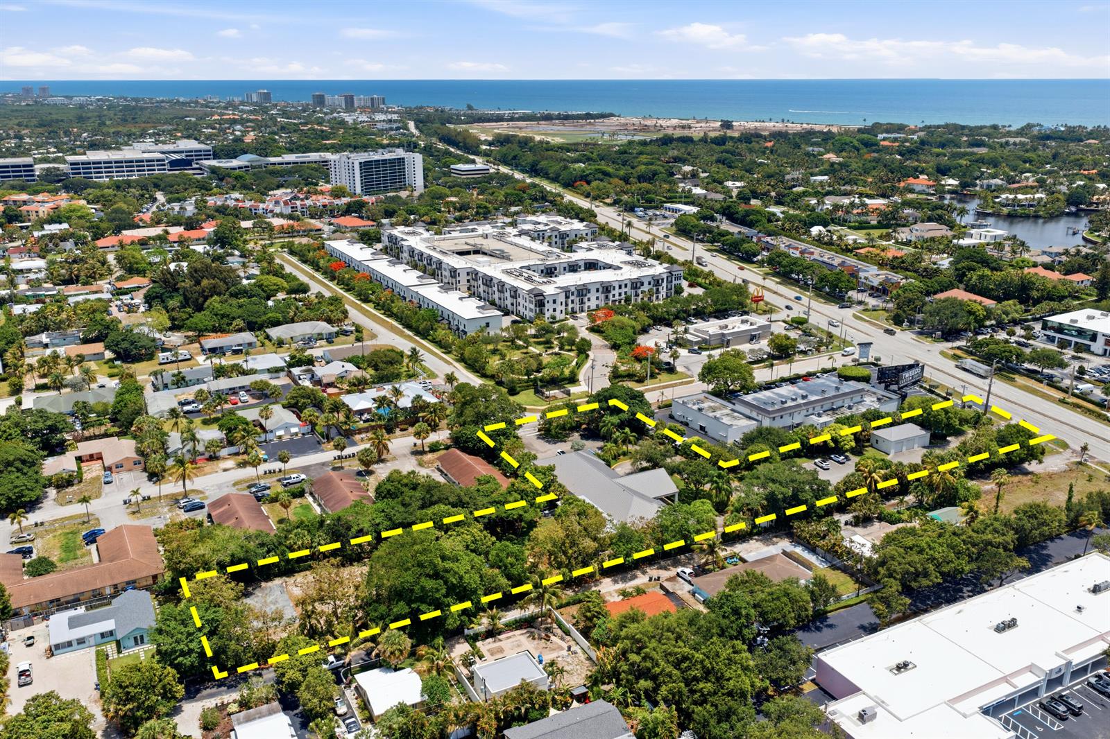 An aerial view shows a property outlined in yellow with trees and surrounding buildings — 11981 Us Highway 1, Juno Beach FL 33408, JUNO BEACH, FL