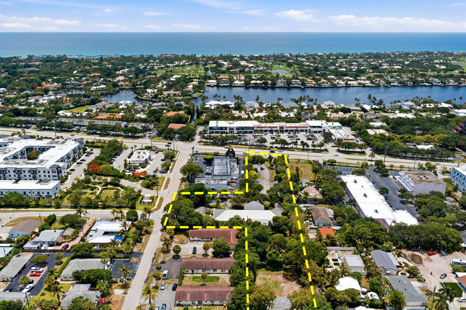 An aerial view shows a commercial property outlined in yellow near a coastal residential area — 11981 Us Highway 1, Juno Beach FL 33408, JUNO BEACH, FL