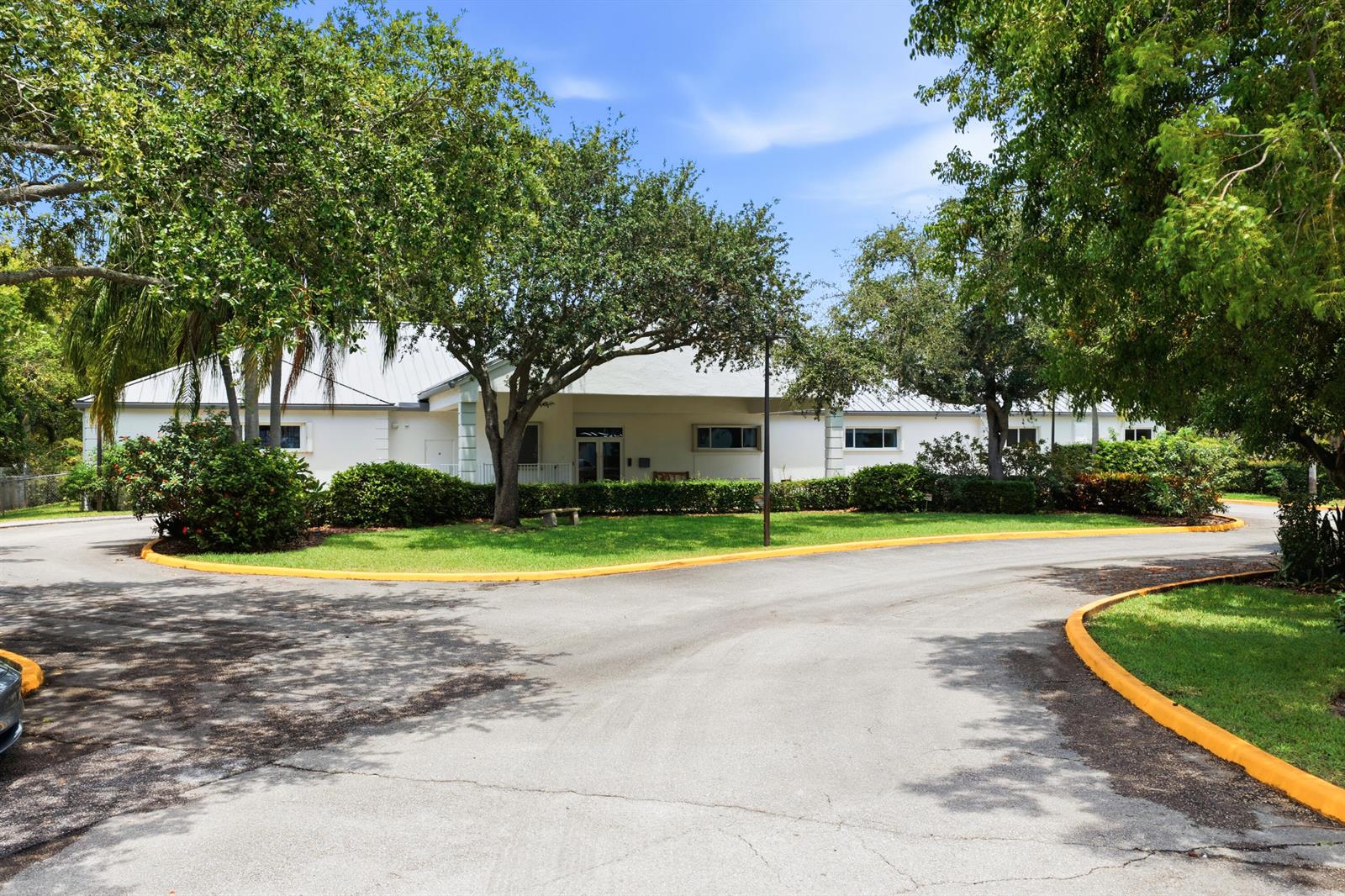 A single-story white building with a metal roof sits behind a curved asphalt driveway — 11981 Us Highway 1, Juno Beach FL 33408, JUNO BEACH, FL