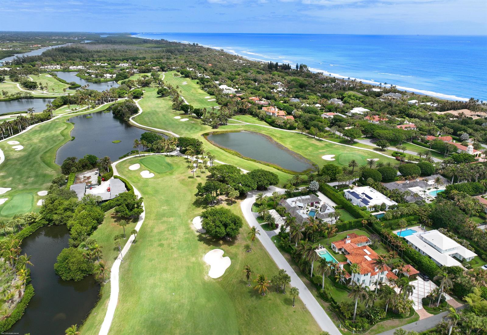An aerial view shows a golf course with ponds, lush landscaping, and several luxury homes — 55 Links Road, Jupiter Island FL 33455, JUPITER ISLAND, FL