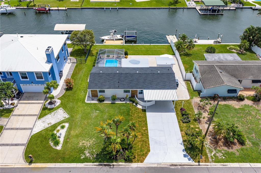 An aerial view of a waterfront house with a pool, boat dock, and driveway — 5004 ARLINGTON ROAD, PALMETTO, FL