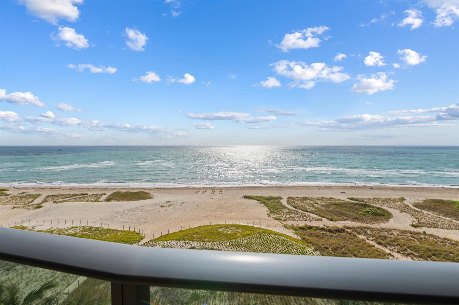 A view of the ocean and beach from a balcony with a metal railing — 900 N Ocean Boulevard # 802, Pompano Beach FL 33062, POMPANO BEACH, FL