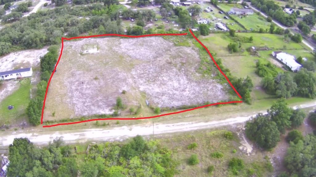 An aerial view shows a cleared, rectangular plot of land outlined in red — 4535 SARVER AVENUE, LAKE WALES, FL