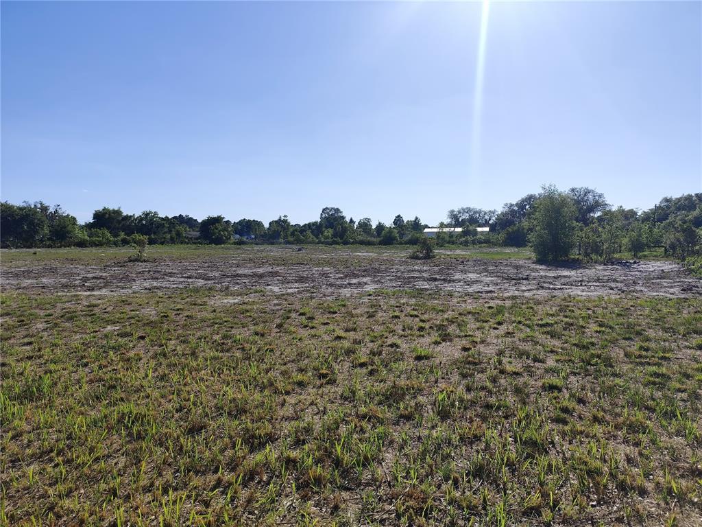 A wide, flat, cleared grassy lot under a clear blue sky — 4535 SARVER AVENUE, LAKE WALES, FL