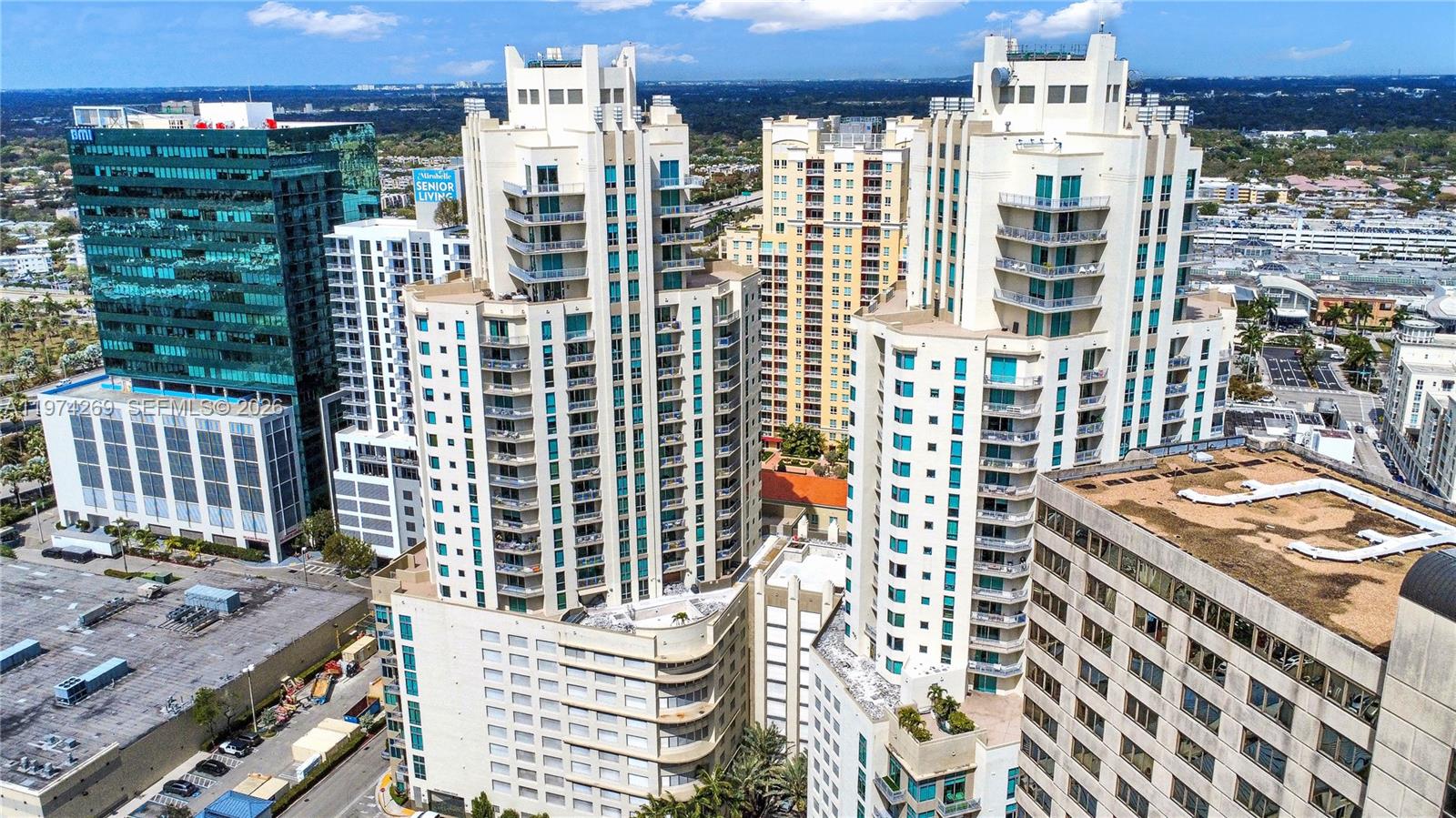 An aerial view shows several high-rise residential and commercial buildings in a dense urban area — 9066 SW 73rd Ct # 203, Miami FL 33156, MIAMI, FL
