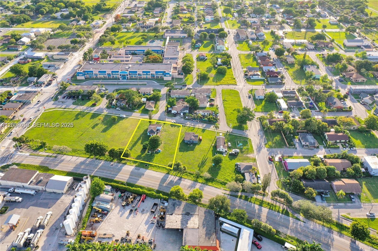 An aerial view shows a residential lot outlined in yellow with a house and trees — 705 SW 3rd Ave, Homestead FL 33030, HOMESTEAD, FL
