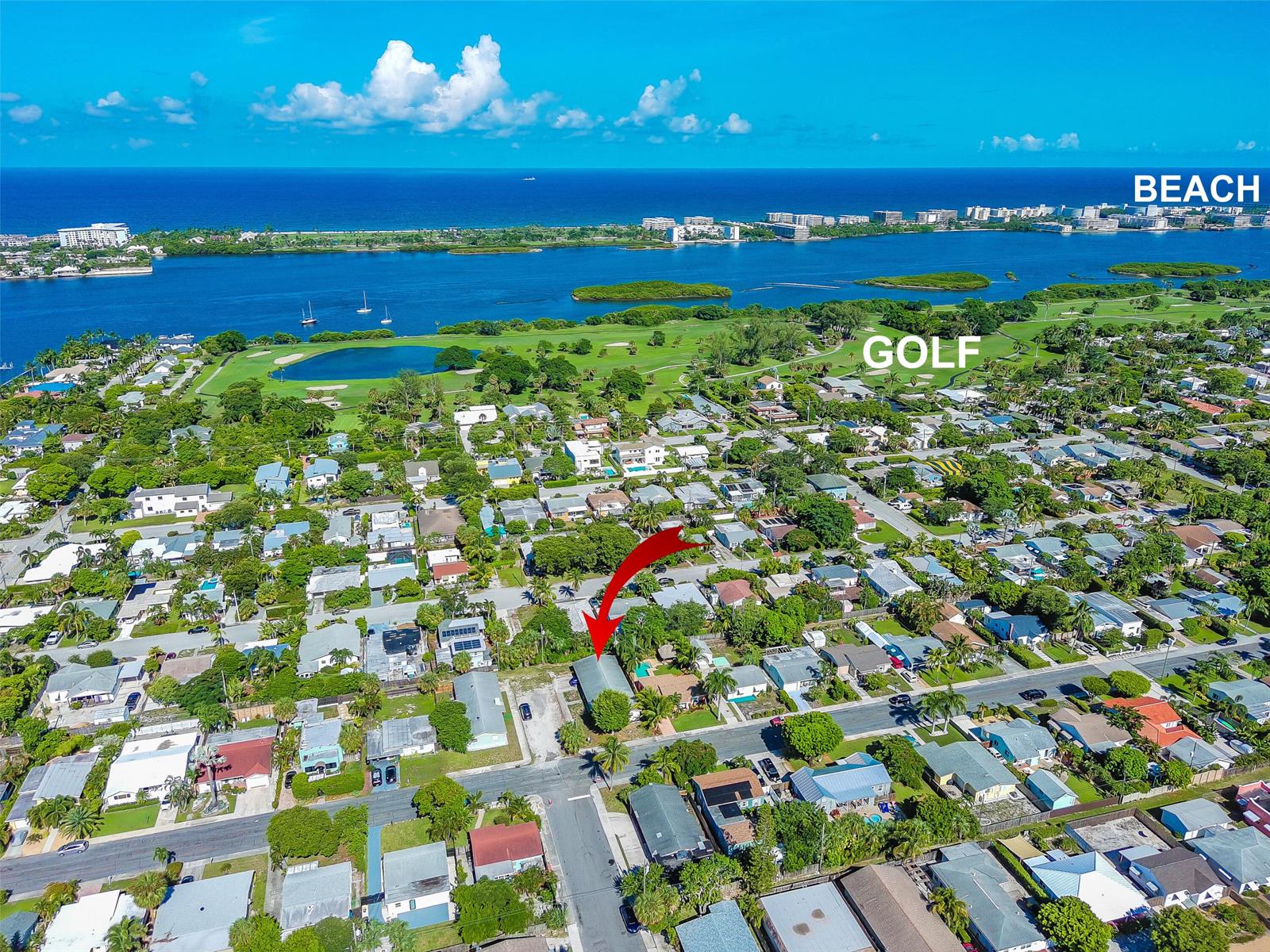 A single-story yellow house with a carport and a blue car parked in the driveway — 1430 N N Street, FL 33460, FL