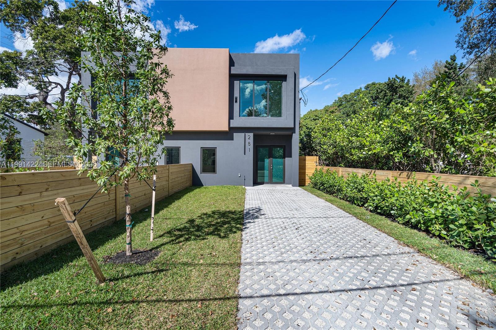 A modern two-story house features a gray and tan facade with a paved driveway — 283 NW 52 St # 283, Miami FL 33127, MIAMI, FL