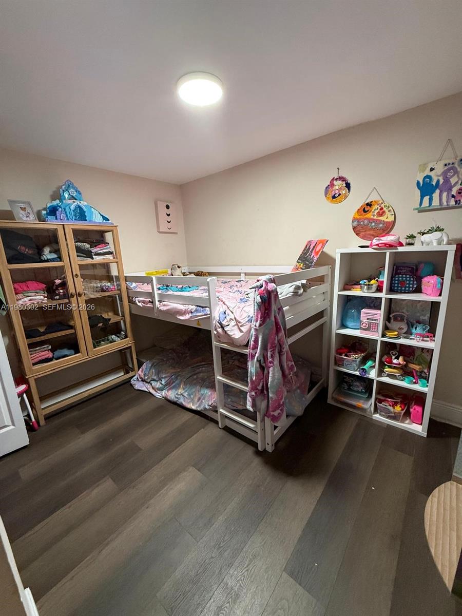 A child's bedroom features a white bunk bed, a wooden cabinet, and a white shelving unit — 5290 SW 22nd Ter, Dania Beach FL 33312, DANIA BEACH, FL