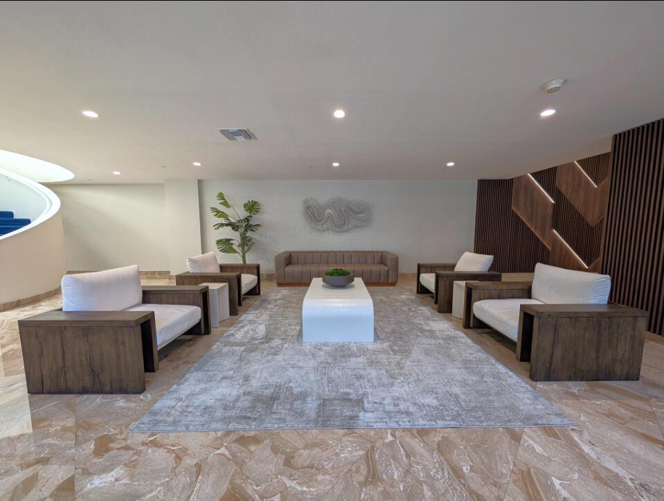A modern lobby features a seating area with a sofa, four armchairs, and a coffee table — 1370 S Ocean Boulevard S # 1403, Pompano Beach FL 33062, POMPANO BEACH, FL