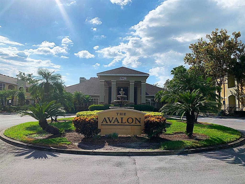 A sign for The Avalon sits in front of a building with a fountain — 1234 S MISSOURI AVENUE UNIT 316, CLEARWATER, FL