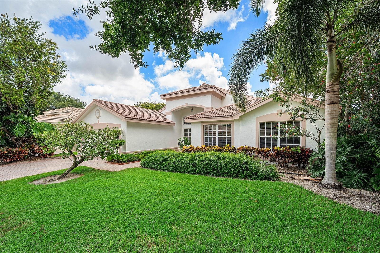 A single-story white house with a tile roof, palm tree, and manicured lawn — 11631 Puerto Boulevard, Boynton Beach FL 33437, BOYNTON BEACH, FL