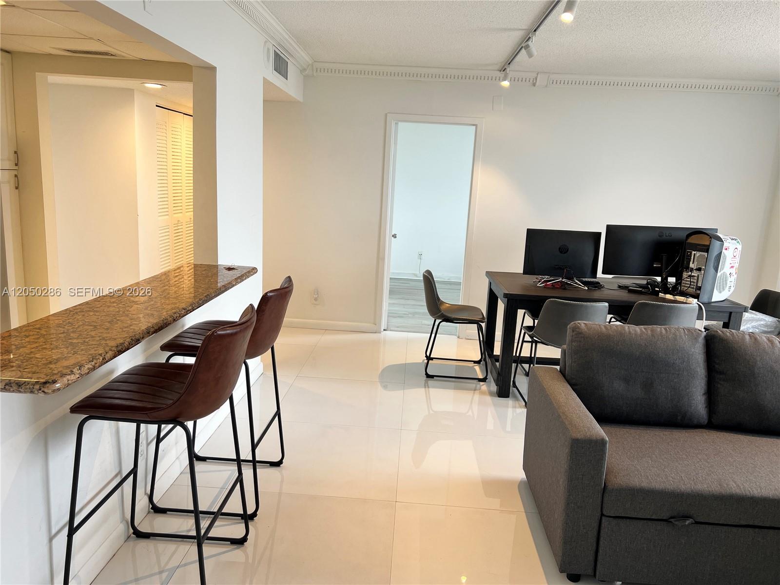 A living area features white tile floors, a granite breakfast bar, and a computer desk — 13499 Biscayne Blvd # 1407, North Miami FL 33181, NORTH MIAMI, FL