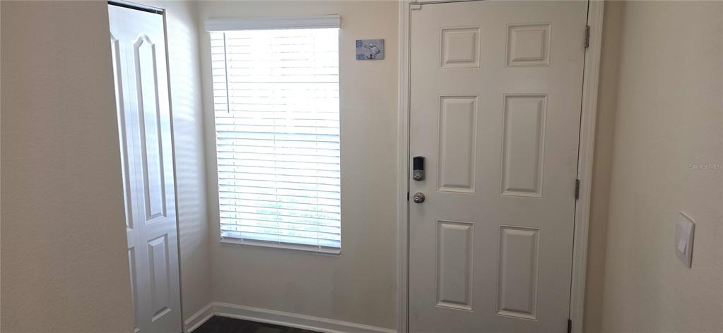 An entryway features a white door, a window with blinds, and a closet door — 16 PINNACLE PLACE, BUNNELL, FL