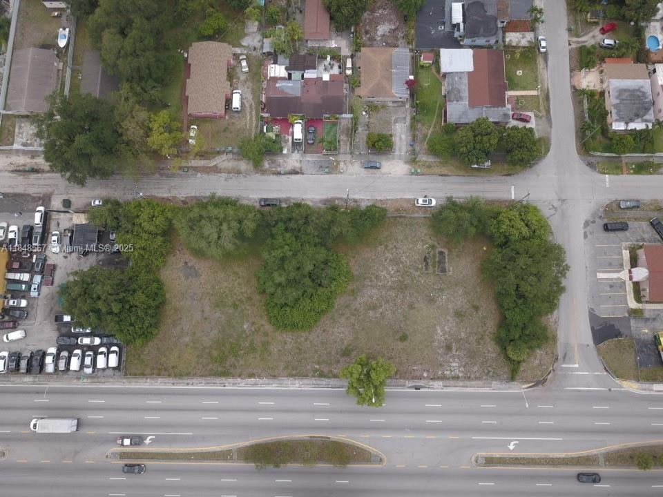 An aerial view shows a vacant, rectangular lot bordered by a road and a highway — 2801 NW 102nd St, Miami FL 33165, MIAMI, FL