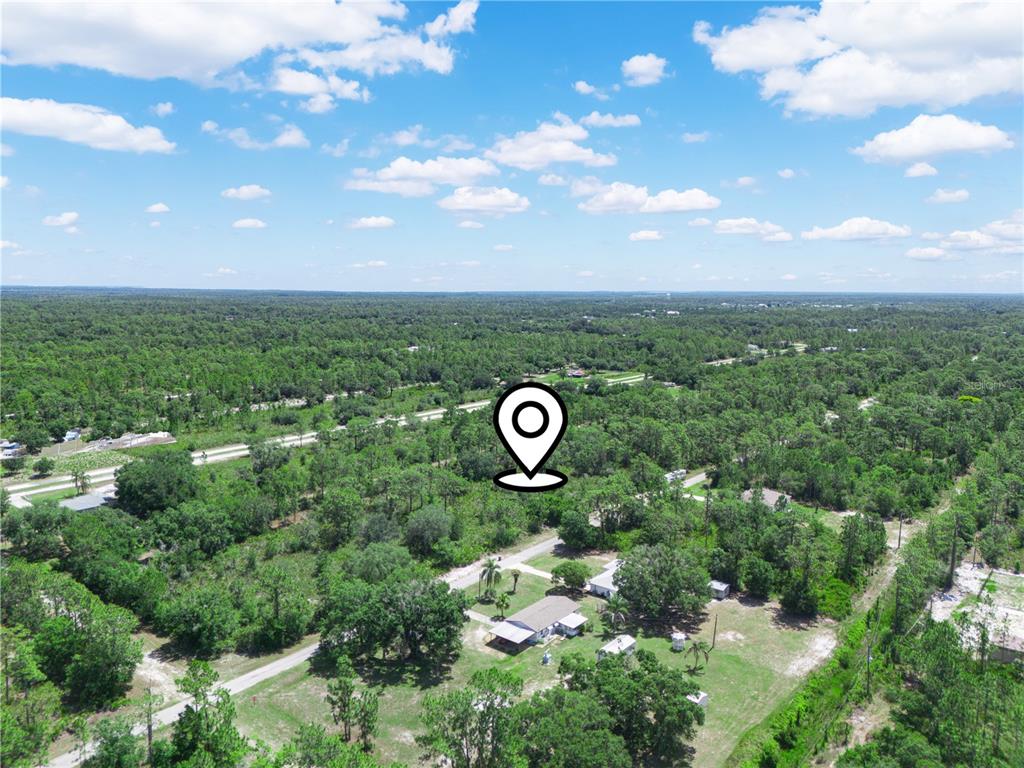 An aerial view shows a wooded lot with a house and a location pin — 618 GARDENIA DRIVE, INDIAN LAKE ESTATES, FL