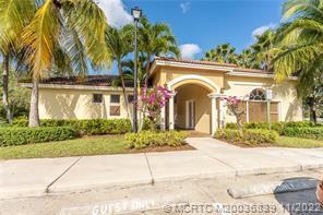 A beige single-story building with a covered arched entrance and surrounding palm trees — 49 SE Sedona Circle # 101, Stuart FL 34994, STUART, FL