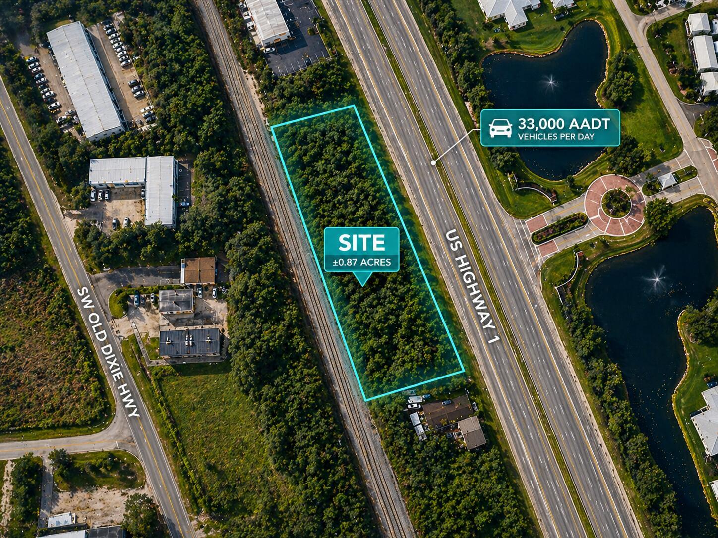 An aerial view shows a rectangular wooded lot situated between a highway and railroad tracks — 1437 U.s. 1, Vero Beach FL 32960, VERO BEACH, FL