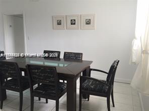 A dining room features a dark wood table with chairs and three framed wall pictures — 250 S Shore Dr # 5, Miami Beach FL 33141, MIAMI BEACH, FL