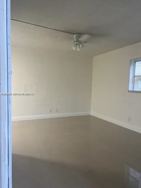 An empty room with white walls, light-colored tile flooring, and a ceiling fan — 4169 SW 67th Ave # 116A, Davie FL 33314, DAVIE, FL
