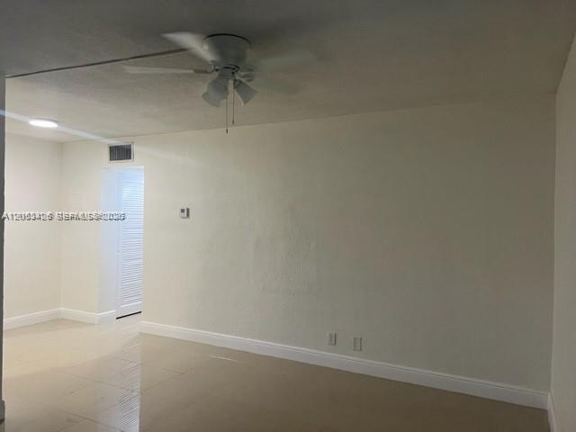 An empty room with light-colored tile floors, white walls, and a ceiling fan — 4169 SW 67th Ave # 116A, Davie FL 33314, DAVIE, FL