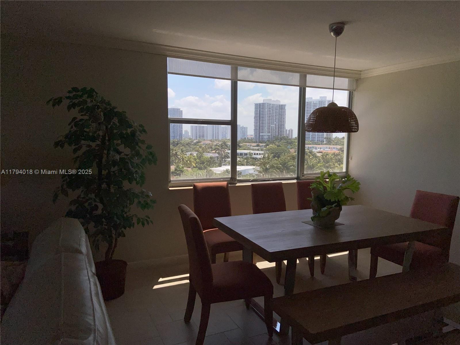 A dining room features a wooden table, six chairs, a bench, and a city view — 3180 S Ocean Dr # 716, Hallandale Beach FL 33009, HALLANDALE BEACH, FL