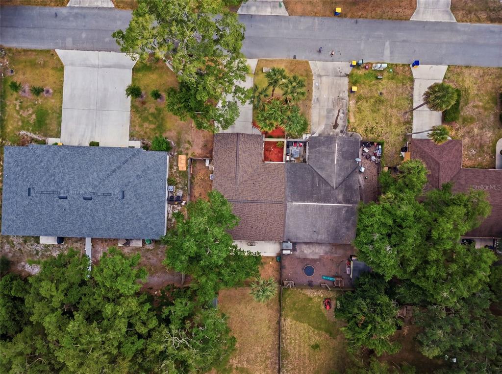 An aerial view shows a single-story house with a driveway and surrounding trees — 1302 BOND STREET, EDGEWATER, FL