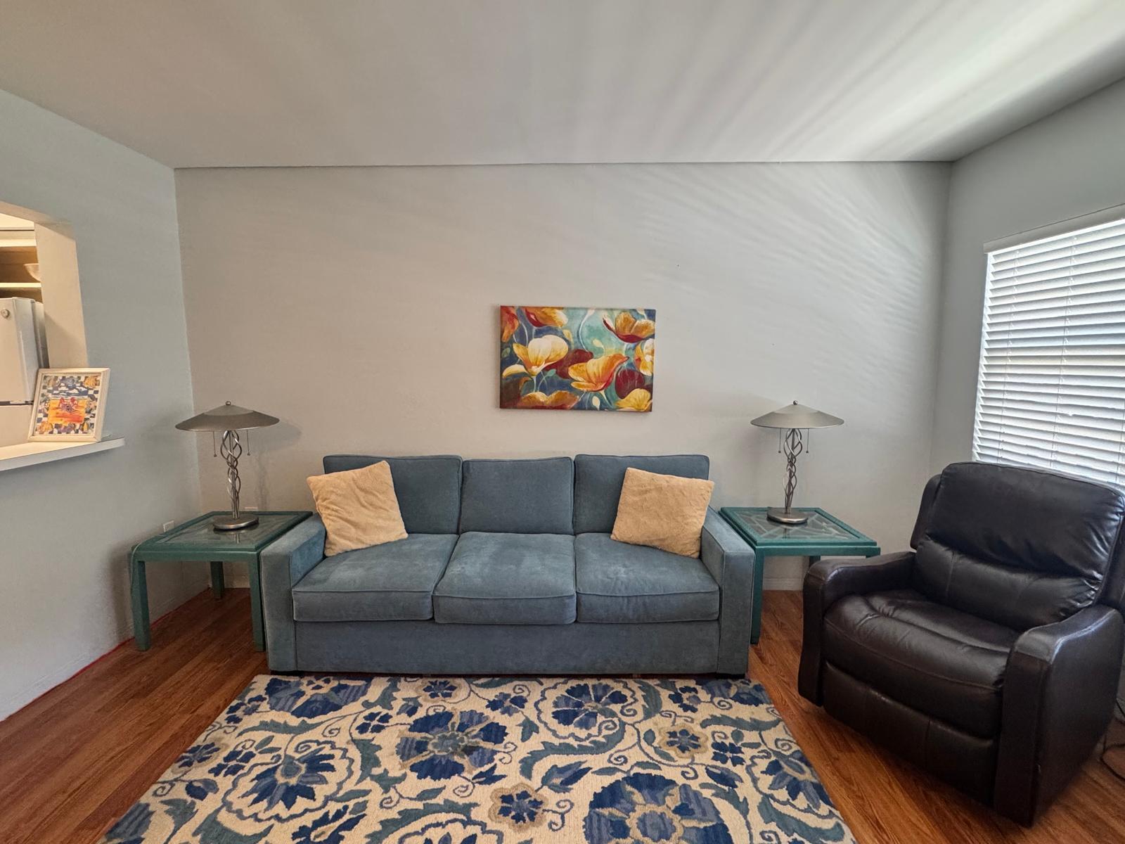 A living room features a blue sofa, two side tables with lamps, and a patterned rug — 2001 S Ocean Drive # 46, Hallandale Beach FL 33009, HALLANDALE BEACH, FL