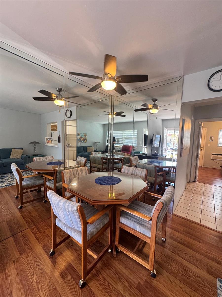 A dining area features an octagonal glass table, wooden chairs, and a large mirrored wall — 2001 S Ocean Drive # 46, Hallandale Beach FL 33009, HALLANDALE BEACH, FL