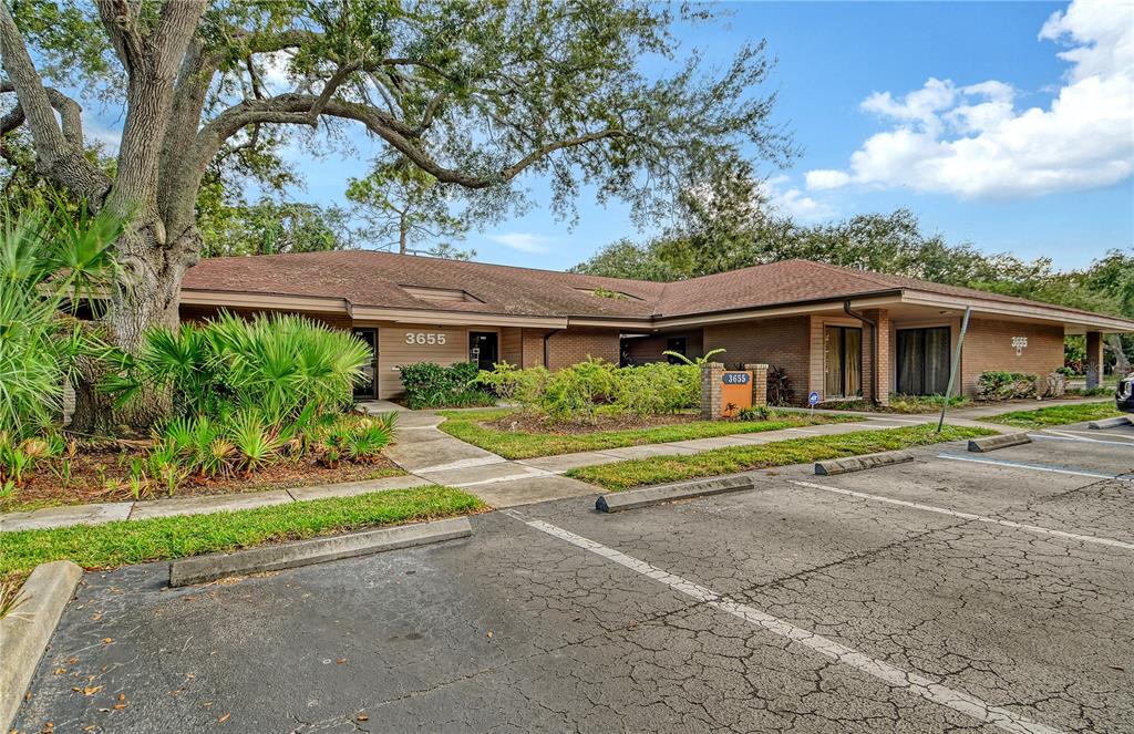 A single-story brick office building with a parking lot and mature trees in front — 3657 CORTEZ ROAD W UNIT 130, BRADENTON, FL