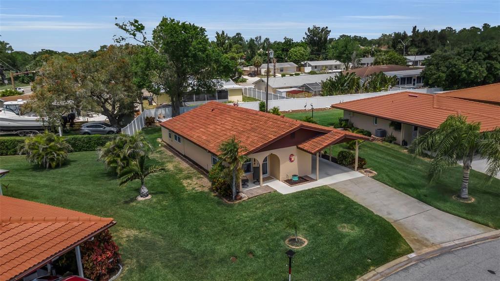 An aerial view of a single-story house with a red tile roof and carport — 3311 MERCER ROAD UNIT 3311, BRADENTON, FL