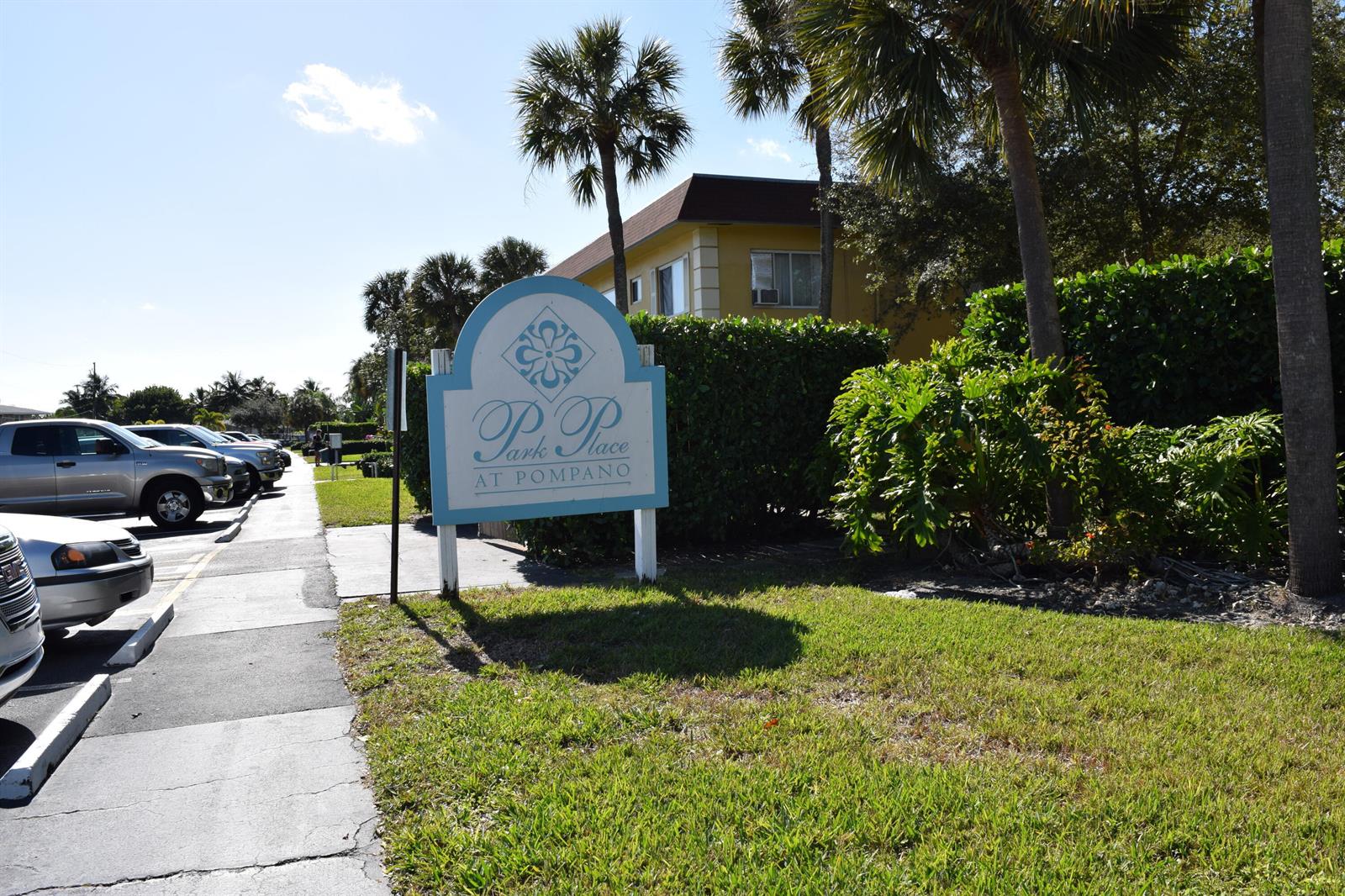 A sign for Park Place at Pompano stands in front of a yellow apartment building — 151 SE 6th Avenue # 14, Pompano Beach FL 33060, POMPANO BEACH, FL