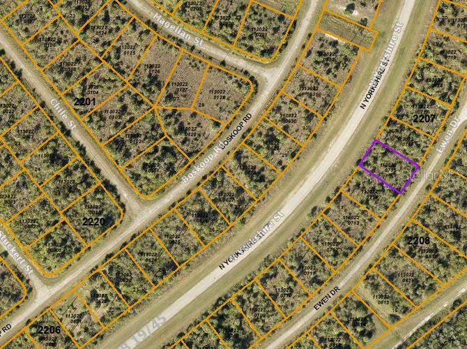 This is an aerial map showing a vacant lot highlighted in purple within a residential subdivision — EWEN DRIVE, NORTH PORT, FL