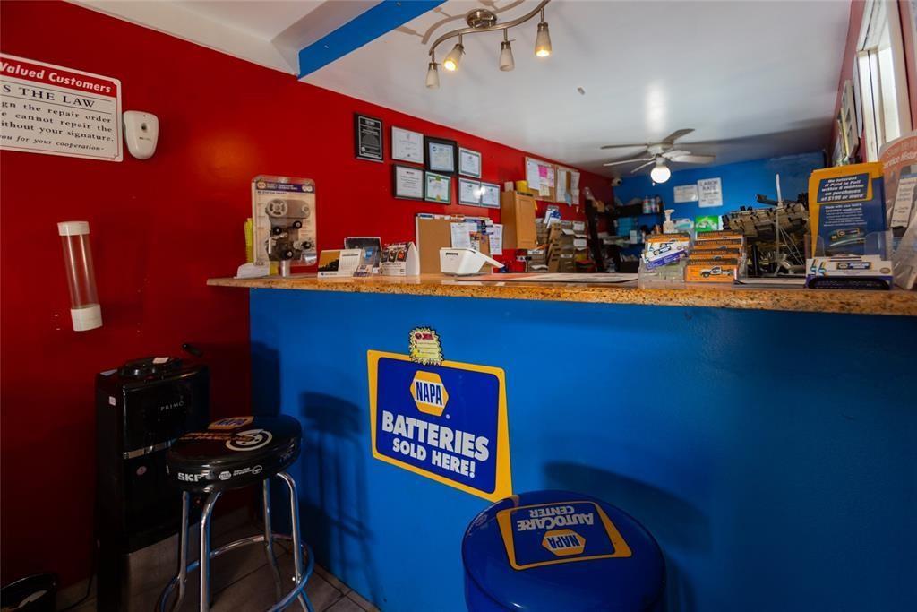 A service counter with a blue base and granite top sits in a room with red walls — 669 NW 26th Street, Miami FL 33127, MIAMI, FL
