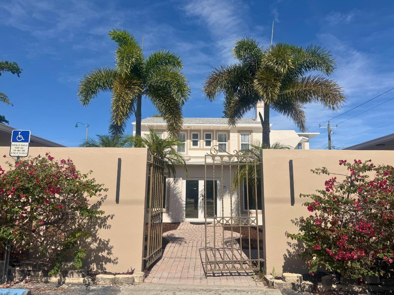 A two-story building with palm trees and a gated brick walkway entrance — 3600 Broadway, West Palm Beach FL 33407, WEST PALM BEACH, FL