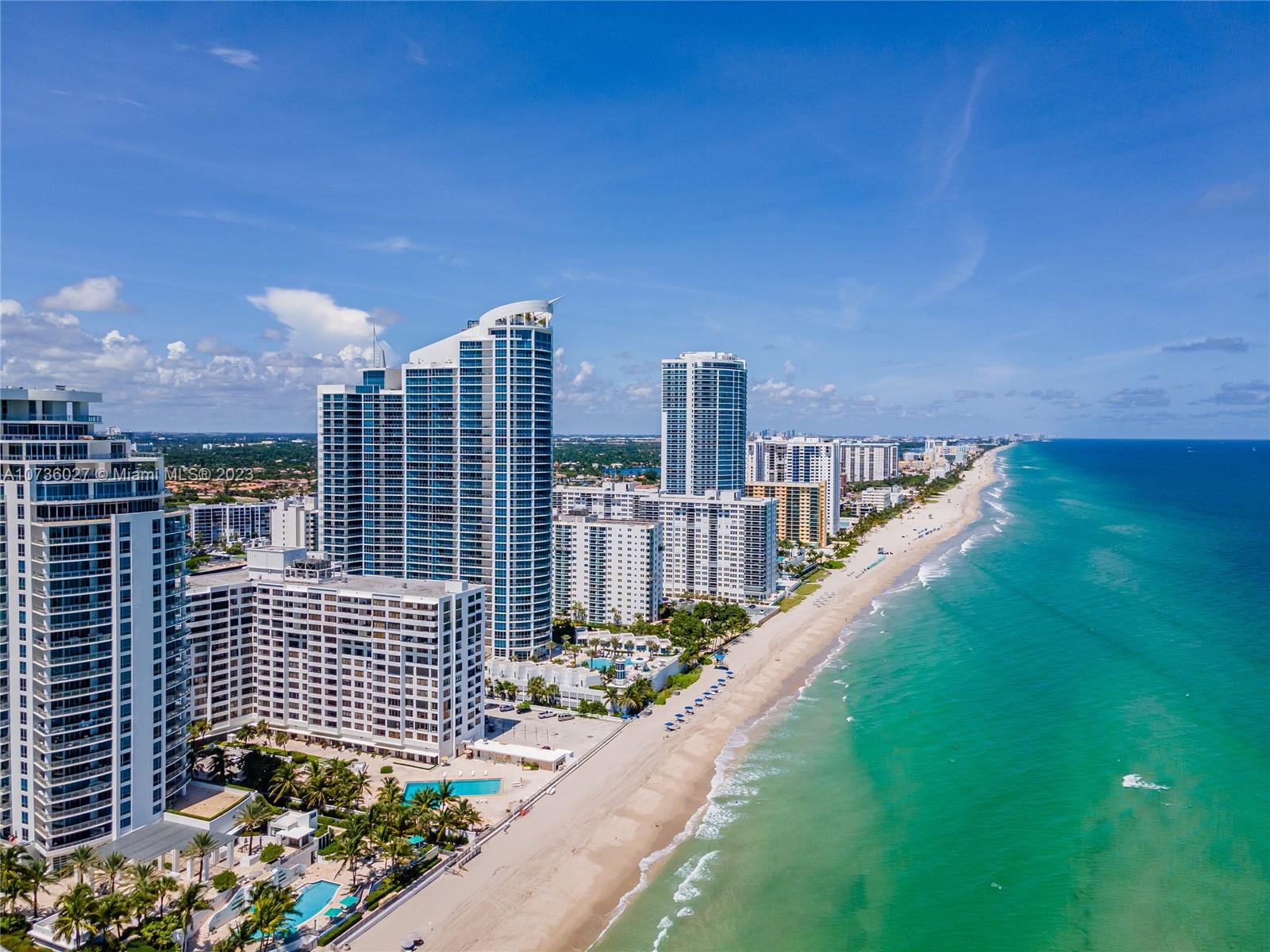 An aerial view of a sandy beach lined with high-rise residential buildings and the ocean — 2501 S OCEAN DR, Hollywood FL 33019, HOLLYWOOD, FL