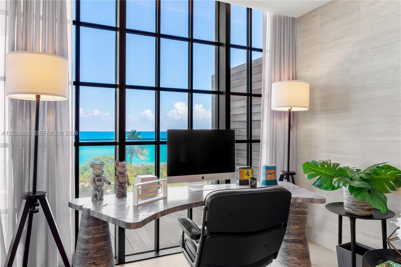 A home office features a stone desk, a computer, and floor-to-ceiling windows overlooking the ocean — 8955 E Collins Ave # 301, Surfside FL 33154, SURFSIDE, FL