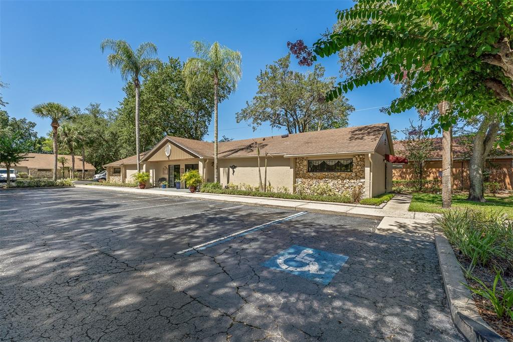 A single-story commercial building with a stone facade and a handicap-accessible parking space — 7210 CURRY FORD ROAD UNIT 2B, ORLANDO, FL